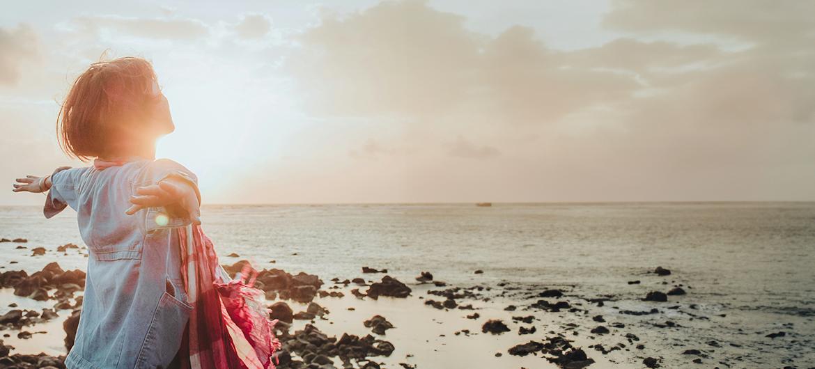 girl enjoying fresh air and water at the beach