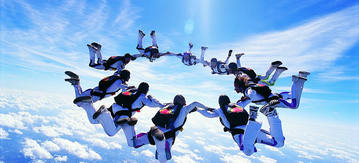Parachuters forming a circle - United we will never be defeated